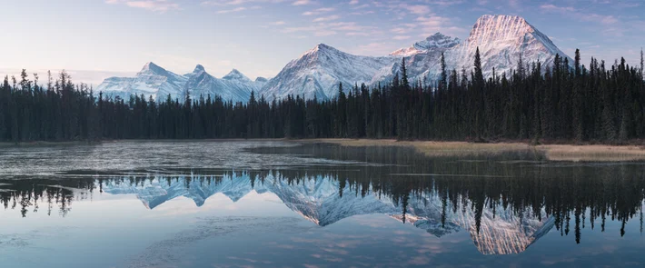 Reflection of snow covered mountains in a still lake