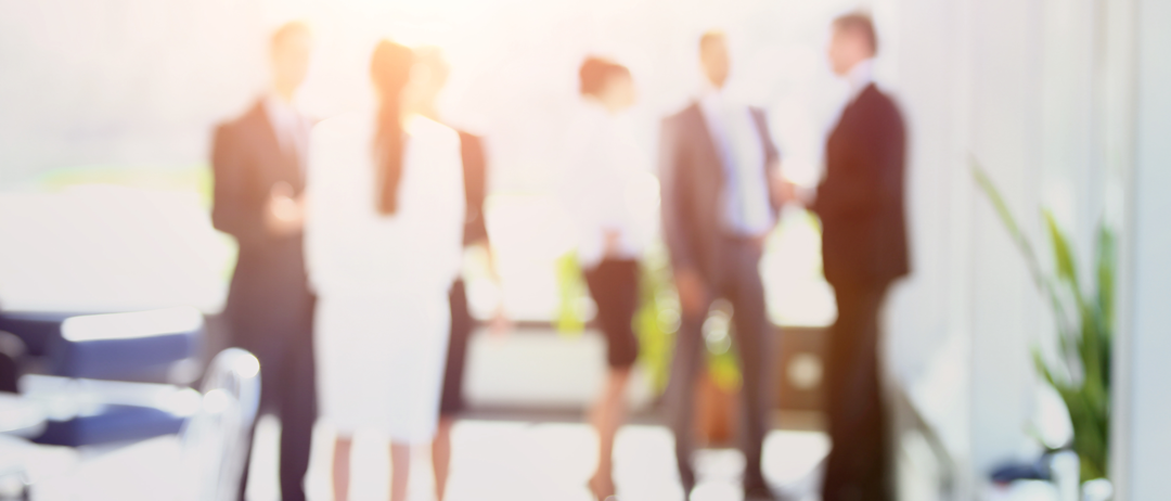 sunlit-executives-conversing-in-boardroom